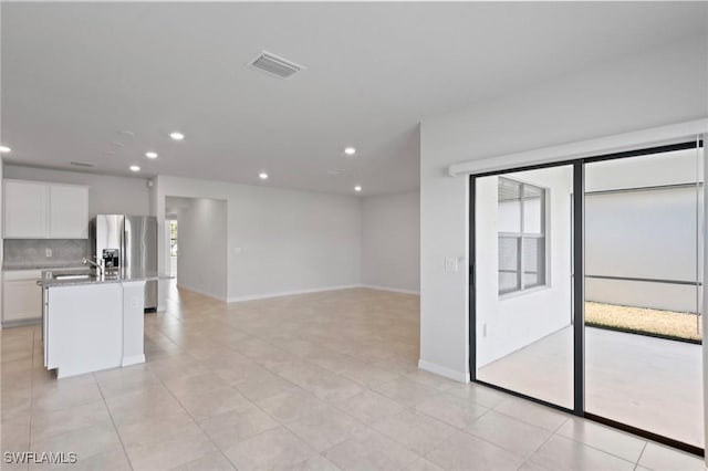 16044 Enclaves Cove Dr, North Fort Myers, FL 33917 - interior space featuring visible vents, recessed lighting, stainless steel refrigerator with ice dispenser, and white cabinets