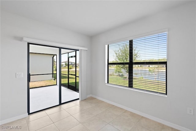 16044 Enclaves Cove Dr, North Fort Myers, FL 33917 - unfurnished room with baseboards and light tile patterned floors