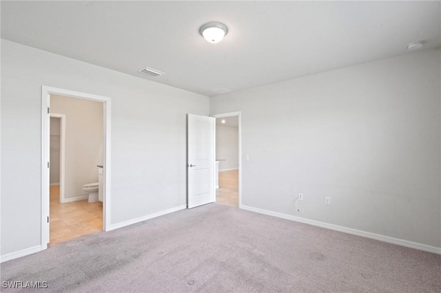 16044 Enclaves Cove Dr, North Fort Myers, FL 33917 - unfurnished bedroom with carpet floors, baseboards, ensuite bathroom, and visible vents