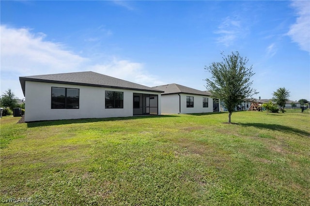 16044 Enclaves Cove Dr, North Fort Myers, FL 33917 - rear view of property with a lawn and stucco siding