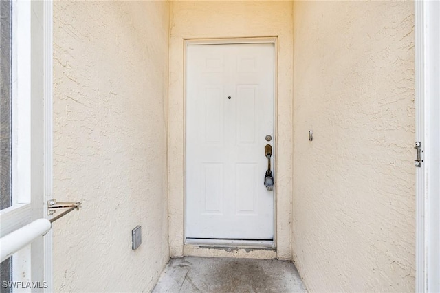 entrance to property featuring stucco siding