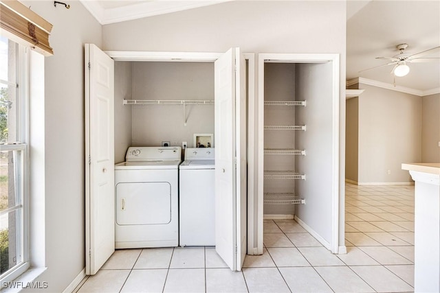 laundry area with laundry area, crown molding, a healthy amount of sunlight, and washer and dryer