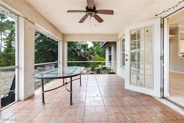 sunroom featuring ceiling fan