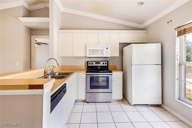 kitchen featuring a sink, a peninsula, white appliances, and white cabinets