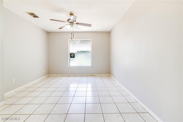 unfurnished room with a ceiling fan, light tile patterned floors, and visible vents