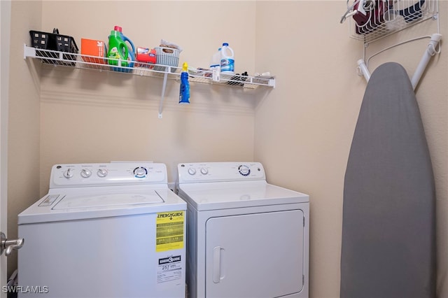 washroom with laundry area and washer and dryer