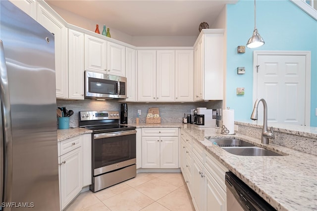 kitchen with a sink, light tile patterned floors, backsplash, and stainless steel appliances