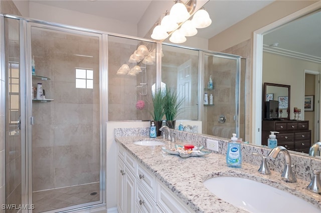 bathroom featuring double vanity, a notable chandelier, a sink, and a stall shower