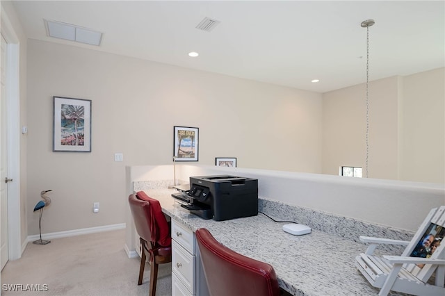 dining space with visible vents, baseboards, built in desk, and light colored carpet