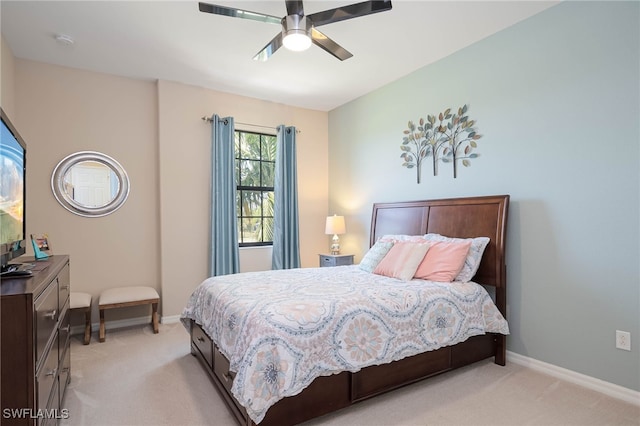 bedroom with baseboards, light carpet, and a ceiling fan