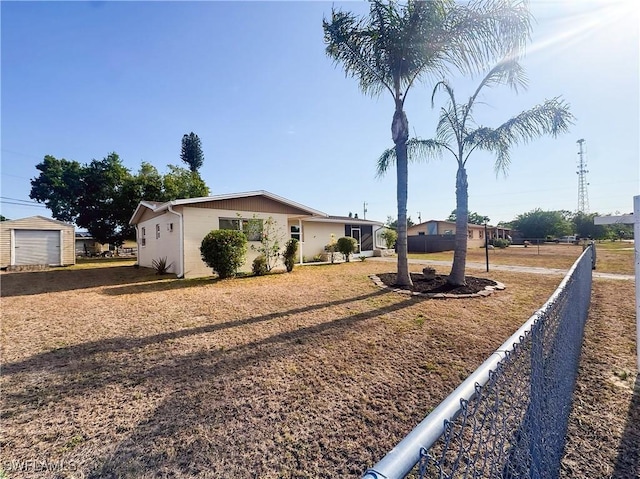 508 Wyoming Rd, Lehigh Acres, FL 33936 - view of front facade with fence, an outbuilding, and a storage unit