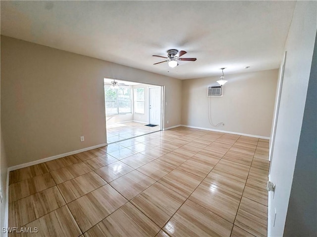 508 Wyoming Rd, Lehigh Acres, FL 33936 - spare room featuring a ceiling fan, an AC wall unit, baseboards, and light tile patterned floors