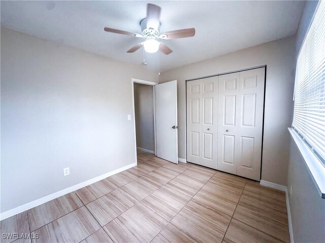508 Wyoming Rd, Lehigh Acres, FL 33936 - unfurnished bedroom with a closet, baseboards, ceiling fan, and light tile patterned floors