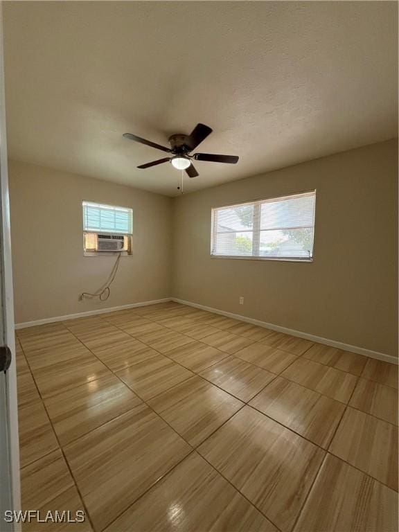 508 Wyoming Rd, Lehigh Acres, FL 33936 - spare room with light tile patterned floors, baseboards, a ceiling fan, and cooling unit