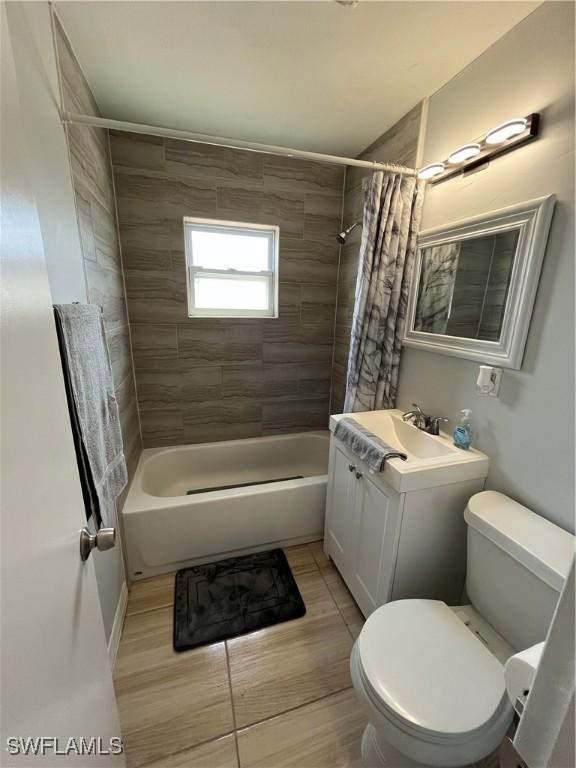 508 Wyoming Rd, Lehigh Acres, FL 33936 - bathroom featuring toilet, shower / bath combination with curtain, and vanity