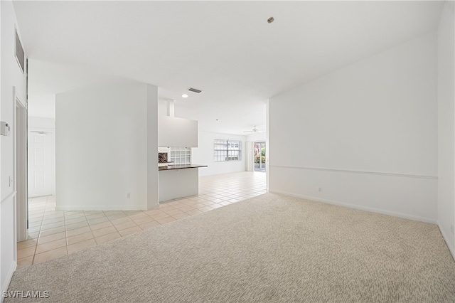 4788 San Carlo Ct, Naples, FL 34109 - unfurnished living room featuring light tile patterned floors, recessed lighting, light colored carpet, and a ceiling fan