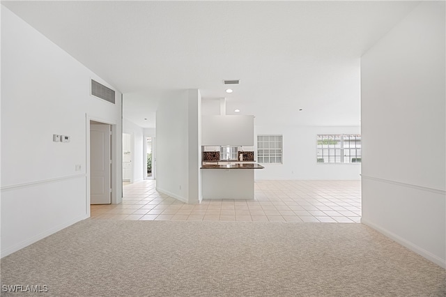 4788 San Carlo Ct, Naples, FL 34109 - unfurnished living room with light tile patterned floors, light carpet, and recessed lighting