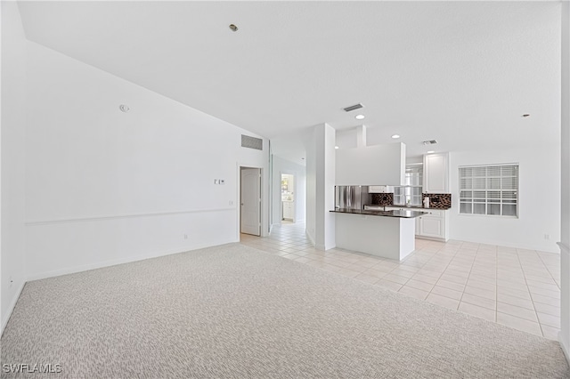 4788 San Carlo Ct, Naples, FL 34109 - unfurnished living room featuring light tile patterned floors, recessed lighting, and light carpet