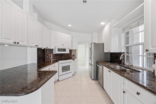 4788 San Carlo Ct, Naples, FL 34109 - kitchen with white appliances, white cabinets, tasteful backsplash, and recessed lighting