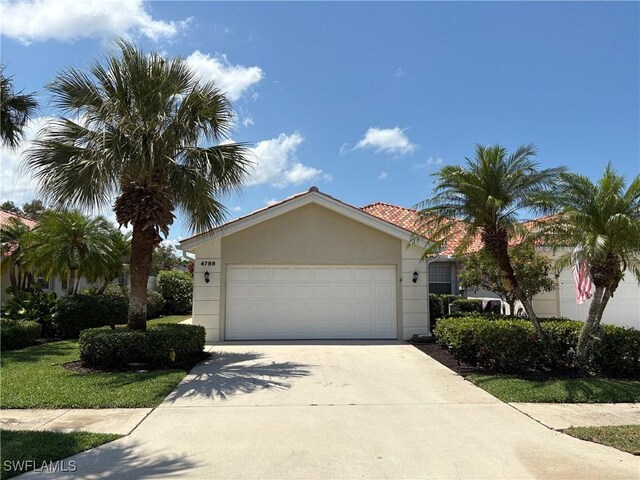 4788 San Carlo Ct, Naples, FL 34109 - view of front of property with driveway, a garage, and stucco siding