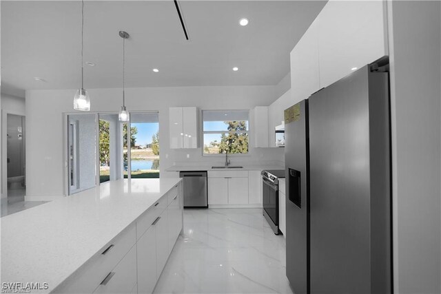 121 NE 8th Ter, Cape Coral, FL 33909 - kitchen featuring modern cabinets, a sink, white cabinets, marble finish floor, and stainless steel appliances