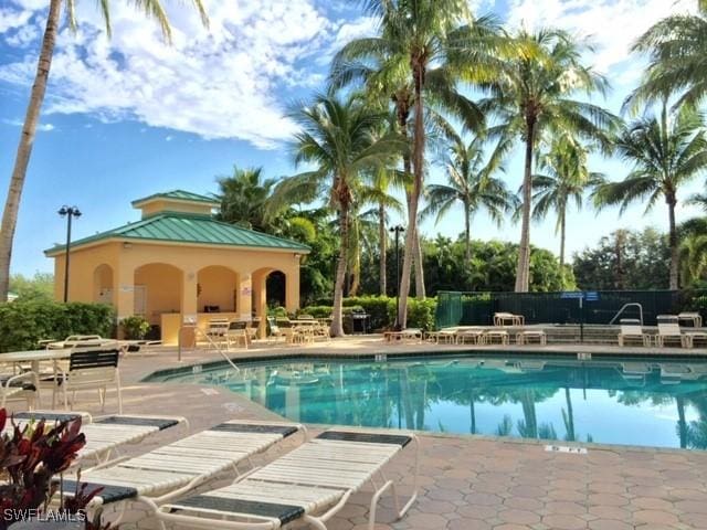community pool with a patio, a gazebo, and fence