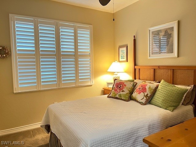carpeted bedroom featuring baseboards