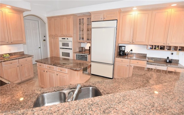 3787 Whippoorwill Ct, Punta Gorda, FL 33950 - kitchen with wine cooler, white double oven, a sink, dark stone countertops, and paneled built in fridge