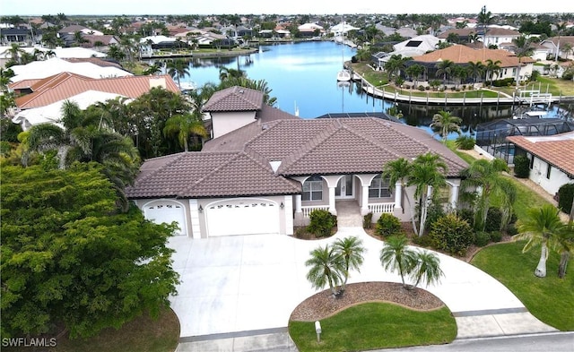 3787 Whippoorwill Ct, Punta Gorda, FL 33950 - view of front of home featuring a tiled roof, a garage, concrete driveway, a water view, and stucco siding