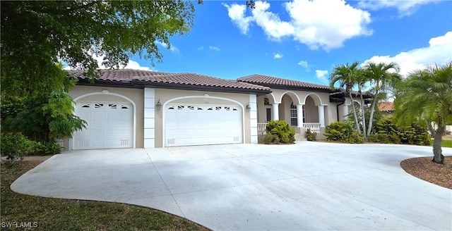 3787 Whippoorwill Ct, Punta Gorda, FL 33950 - mediterranean / spanish-style house with a tiled roof, covered porch, a garage, concrete driveway, and stucco siding