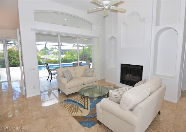 3787 Whippoorwill Ct, Punta Gorda, FL 33950 - living area featuring a ceiling fan, a towering ceiling, a sunroom, and a fireplace