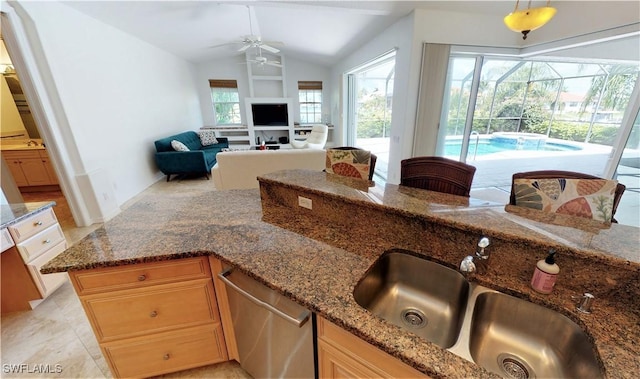 3787 Whippoorwill Ct, Punta Gorda, FL 33950 - kitchen featuring ceiling fan, stainless steel dishwasher, a sink, dark stone countertops, and lofted ceiling
