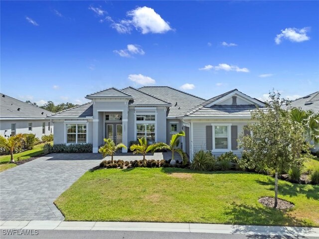 15897 Cranes Marsh Ct, Punta Gorda, FL 33982 - view of front facade featuring a front lawn, stucco siding, and a tile roof