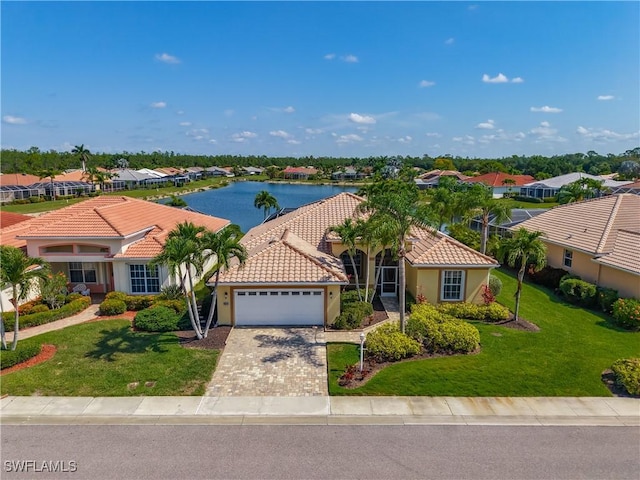 20710 Mystic Way N, Fort Myers, FL 33917 - mediterranean / spanish home with a garage, a residential view, a tile roof, and a water view