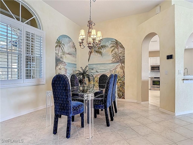 20710 Mystic Way N, Fort Myers, FL 33917 - dining space with a chandelier, light tile patterned floors, and arched walkways