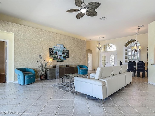 20710 Mystic Way N, Fort Myers, FL 33917 - living room with ceiling fan, arched walkways, a chandelier, and light tile patterned flooring