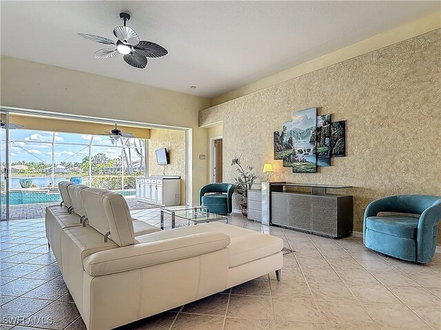 20710 Mystic Way N, Fort Myers, FL 33917 - living room featuring a sunroom, a ceiling fan, and a water view