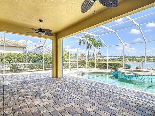 20710 Mystic Way N, Fort Myers, FL 33917 - view of swimming pool featuring ceiling fan, a patio, glass enclosure, a pool with connected hot tub, and a water view