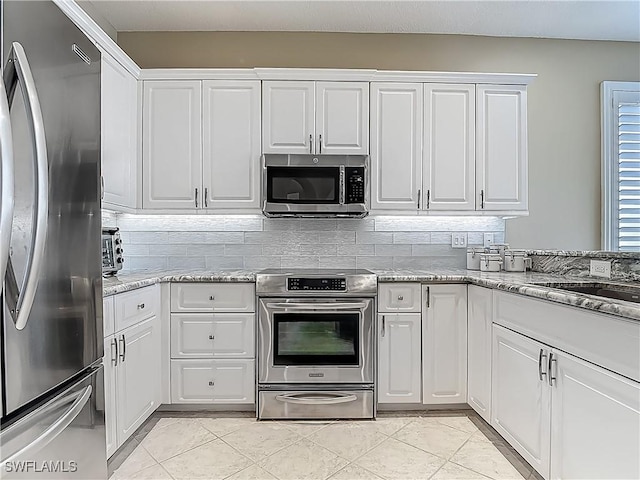 20710 Mystic Way N, Fort Myers, FL 33917 - kitchen with stainless steel appliances, tasteful backsplash, and white cabinets