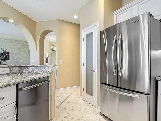 20710 Mystic Way N, Fort Myers, FL 33917 - kitchen with appliances with stainless steel finishes, white cabinets, light tile patterned floors, light stone countertops, and recessed lighting