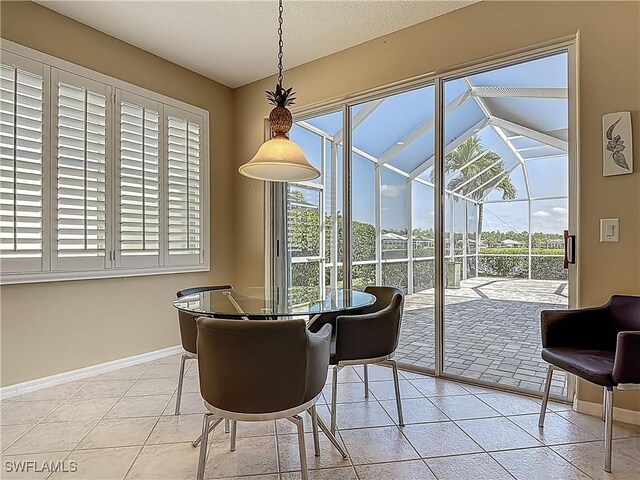 20710 Mystic Way N, Fort Myers, FL 33917 - tiled dining area featuring baseboards, plenty of natural light, and a sunroom