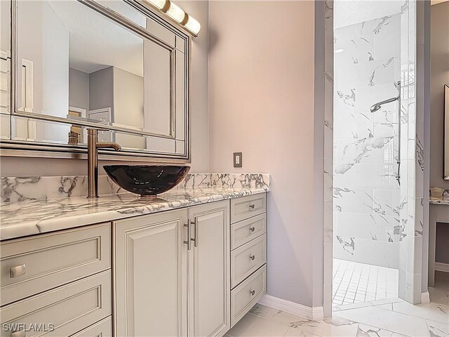 20710 Mystic Way N, Fort Myers, FL 33917 - bathroom featuring marble look tiles, a walk in shower, vanity, and baseboards