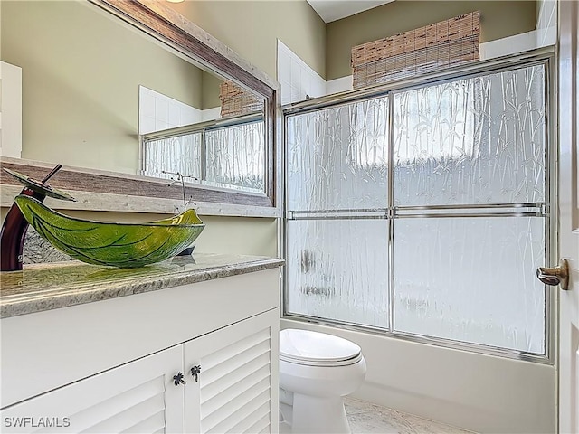 20710 Mystic Way N, Fort Myers, FL 33917 - bathroom featuring toilet, enclosed tub / shower combo, and vanity