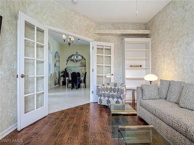 20710 Mystic Way N, Fort Myers, FL 33917 - living area with french doors, arched walkways, a textured wall, wood finished floors, and a chandelier