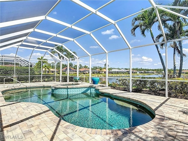 20710 Mystic Way N, Fort Myers, FL 33917 - view of pool with a patio, a pool with connected hot tub, a lanai, and a water view