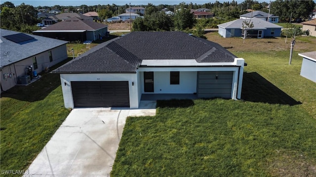 3610 22nd St SW, Lehigh Acres, FL 33976 - view of front facade with a residential view, an attached garage, driveway, and a front yard