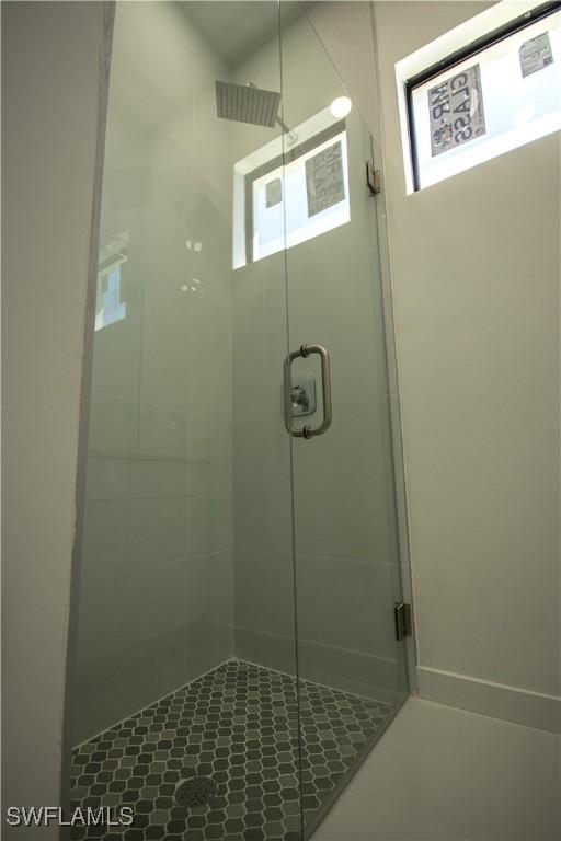 3610 22nd St SW, Lehigh Acres, FL 33976 - bathroom featuring tile patterned flooring and a stall shower