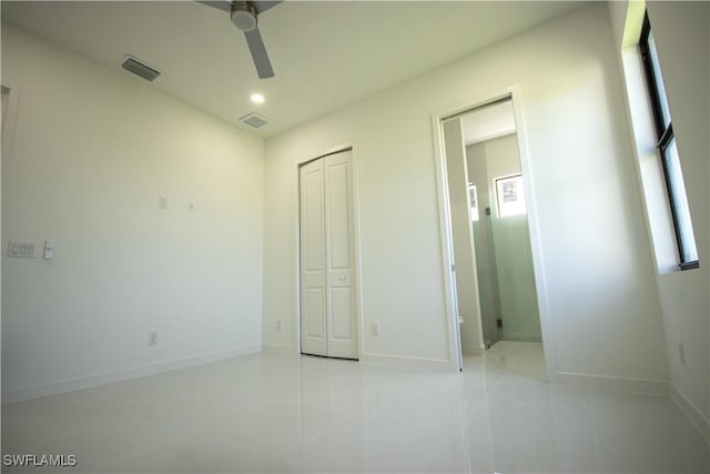 3610 22nd St SW, Lehigh Acres, FL 33976 - unfurnished bedroom with baseboards, a closet, tile patterned floors, and visible vents