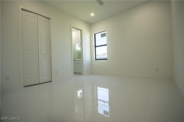 3610 22nd St SW, Lehigh Acres, FL 33976 - unfurnished bedroom with recessed lighting, baseboards, ensuite bath, and light tile patterned floors