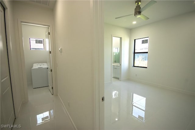 3610 22nd St SW, Lehigh Acres, FL 33976 - hall with visible vents, baseboards, washer / clothes dryer, and light tile patterned floors